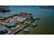 Waterfront homes boast pools, docks, and manicured grounds, captured in an elevated view with ocean backdrop at 5434 Oakhurst Dr, Seminole, FL 33772