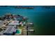 Waterfront homes with private docks and pools, seen from above with a stunning ocean view in the background at 5434 Oakhurst Dr, Seminole, FL 33772