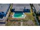 Aerial view of a private backyard featuring a green pool, patio, and landscaping at 5434 Oakhurst Dr, Seminole, FL 33772