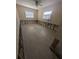 Bedroom with new light colored floors and two windows is in the middle of a remodel at 5434 Oakhurst Dr, Seminole, FL 33772