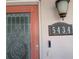 Close up of a home's front door that features the address and an elegant decorative glass window at 5434 Oakhurst Dr, Seminole, FL 33772