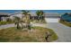 Charming single Gathering home with a two car garage, mature palm trees, and beautiful paved driveway at 5434 Oakhurst Dr, Seminole, FL 33772