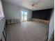 Living room features a ceiling fan, sliding glass doors to the pool, and light flooring undergoing renovation at 5434 Oakhurst Dr, Seminole, FL 33772