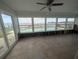 Sunroom with tiled floors and water views, surrounded by large windows at 5434 Oakhurst Dr, Seminole, FL 33772