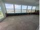 Sunroom with many windows offering natural light and waterfront views of the pool and dock at 5434 Oakhurst Dr, Seminole, FL 33772