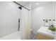 Modern bathroom with stylish tile, a shower-tub combo, and sleek fixtures at 5809 Dartmouth N Ave, St Petersburg, FL 33710