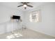 Minimalist bedroom featuring a modern desk and chair, a ceiling fan, terrazzo flooring, and natural light at 5809 Dartmouth N Ave, St Petersburg, FL 33710
