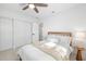 Bright bedroom featuring terrazzo flooring, a ceiling fan, a wooden bed frame, and plenty of natural light at 5809 Dartmouth N Ave, St Petersburg, FL 33710