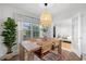 Inviting dining room with a large window, stylish light fixture, and comfortable seating for four at 5809 Dartmouth N Ave, St Petersburg, FL 33710