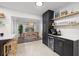 Eat-in kitchen with bar space, stainless steel appliances and decorative floating shelves at 5809 Dartmouth N Ave, St Petersburg, FL 33710