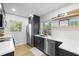 Kitchen with stainless steel appliances, modern cabinetry and bright white countertop at 5809 Dartmouth N Ave, St Petersburg, FL 33710
