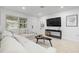 Stylish living room with neutral sectional sofa, modern decor and mounted television at 5809 Dartmouth N Ave, St Petersburg, FL 33710