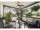 Relaxing screened porch featuring comfortable seating and ceiling fan at 5809 Dartmouth N Ave, St Petersburg, FL 33710