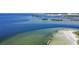 Scenic aerial view of clear Gulf waters and coastline featuring a rocky shoal along a sandy beach and island at 706 Bunker View Dr, Apollo Beach, FL 33572