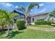 Lush backyard with tropical landscaping and well-maintained lawn at 706 Bunker View Dr, Apollo Beach, FL 33572
