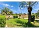 Lush backyard with tropical landscaping and well-maintained lawn at 706 Bunker View Dr, Apollo Beach, FL 33572