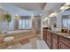 Beautiful bathroom features a soaking tub, walk-in shower, double vanity, and decorative tiling at 706 Bunker View Dr, Apollo Beach, FL 33572