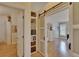 Bedroom featuring a view through sliding barn doors, hardwood floors and natural light at 706 Bunker View Dr, Apollo Beach, FL 33572