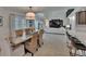 Bright dining area with wooden table and chairs in an open layout near a living room and kitchen at 706 Bunker View Dr, Apollo Beach, FL 33572