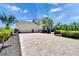 Spacious paver driveway leading to a well-maintained home with a two-car garage and mature landscaping at 706 Bunker View Dr, Apollo Beach, FL 33572
