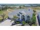 Aerial view of a home featuring lush landscaping and a large driveway at 706 Bunker View Dr, Apollo Beach, FL 33572