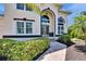Inviting front entrance with paved walkway, trimmed shrubs, and potted plants at the doorstep at 706 Bunker View Dr, Apollo Beach, FL 33572