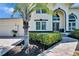Home exterior featuring an arched entryway, well-maintained landscaping, and a paver walkway leading to the front door at 706 Bunker View Dr, Apollo Beach, FL 33572