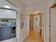 Hallway featuring a laundry room and sliding barn doors leading to a room with wood floors at 706 Bunker View Dr, Apollo Beach, FL 33572