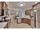 Well-equipped kitchen with stainless steel appliances and a seamless transition to dining area at 706 Bunker View Dr, Apollo Beach, FL 33572