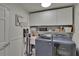 Clean laundry room featuring modern washer and dryer, overhead cabinets and laundry sink at 706 Bunker View Dr, Apollo Beach, FL 33572