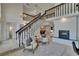 Open-concept living area features a fireplace and staircase to the second floor at 706 Bunker View Dr, Apollo Beach, FL 33572