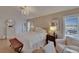 Bright main bedroom features a chandelier, wood floors, and sitting area overlooking the pool at 706 Bunker View Dr, Apollo Beach, FL 33572