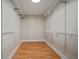 Spacious walk-in closet with wood flooring and multiple shelving units at 706 Bunker View Dr, Apollo Beach, FL 33572