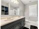 Bathroom with dual sink vanity, tile floors, and great lighting at 103 S Habana Ave, Tampa, FL 33609