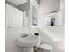 Simple bathroom featuring tiled walls, a sink, and a toilet at 103 S Habana Ave, Tampa, FL 33609