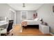 Bedroom featuring hardwood floors, desk, and comfortable furniture at 103 S Habana Ave, Tampa, FL 33609