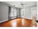 Spacious bedroom featuring hardwood floors, neutral paint, large window, and ceiling fan at 103 S Habana Ave, Tampa, FL 33609