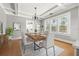Dining room with chandelier, hardwood floors and natural light from large windows at 103 S Habana Ave, Tampa, FL 33609