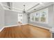 Bright dining room features hardwood floors, coffered ceilings and a chandelier at 103 S Habana Ave, Tampa, FL 33609