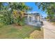 Charming home with lush landscaping, a cozy front porch, and inviting curb appeal at 103 S Habana Ave, Tampa, FL 33609