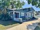 Charming two-story home with a cozy front porch and craftsman details, freshly painted in soothing light-blue color at 103 S Habana Ave, Tampa, FL 33609