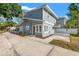 Charming two-story home featuring a well-maintained yard and concrete driveway on a sunny day at 103 S Habana Ave, Tampa, FL 33609