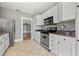 Well-lit kitchen with stainless steel appliances, granite countertops and tile flooring at 103 S Habana Ave, Tampa, FL 33609