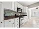 Close-up of the kitchen featuring stainless appliances, granite countertops, and modern backsplash at 103 S Habana Ave, Tampa, FL 33609