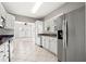 Bright kitchen features white cabinets, stainless steel appliances, and modern finishes at 103 S Habana Ave, Tampa, FL 33609