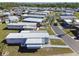 Aerial view of a mobile home community with manicured lawns, paved streets, and manufactured homes with metal roofs at 13225 101St St # 107, Largo, FL 33773