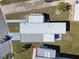 Aerial view of home featuring manicured landscaping, carport, patio, and surrounding neighborhood at 13225 101St St # 107, Largo, FL 33773