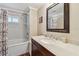 Bright bathroom offers a tub-shower combo and a wooden vanity with white counters at 13225 101St St # 107, Largo, FL 33773