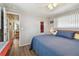 Cozy bedroom with a plush bed, ceiling fan, and ample natural light at 13225 101St St # 107, Largo, FL 33773