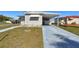 Well-kept home featuring a covered parking area and neatly manicured lawn at 13225 101St St # 107, Largo, FL 33773